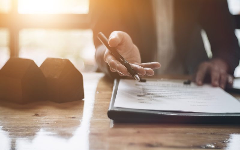 Real estate agent offer hand for customer sign agreement contract signature for buy or sell house. Real estate concept contact agreement concept